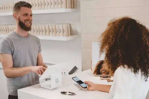 A shopper paying at a store checkout